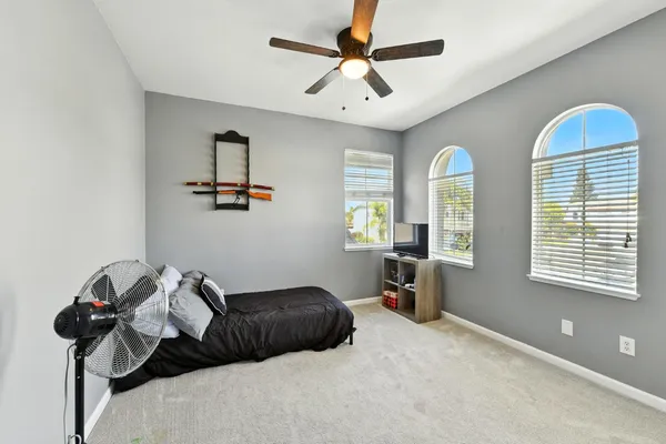 a bedroom with a bed and a chandelier