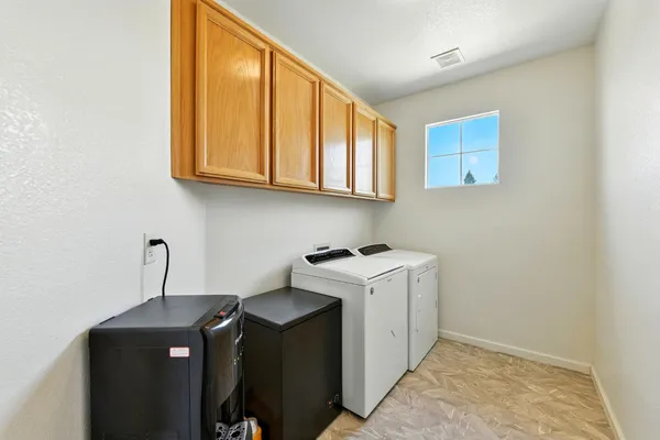 a view of a chair and table in backyard of the house