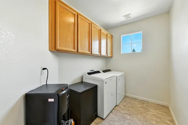a view of a chair and table in backyard of the house