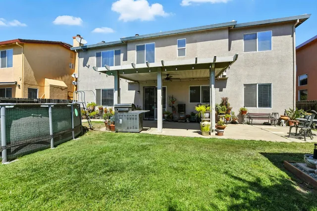 a view of a house with backyard porch and sitting area