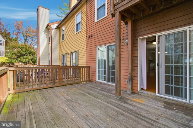 a view of balcony with wooden floor and outdoor seating