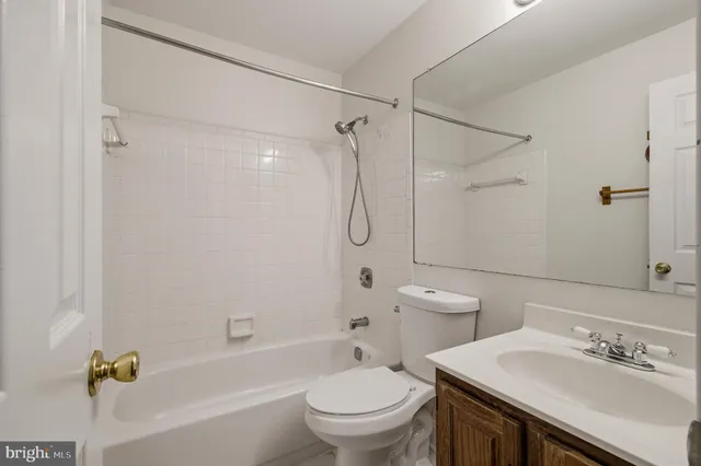 an empty room with a window and a ceiling fan