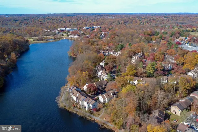 an empty room with wooden floor and a chair