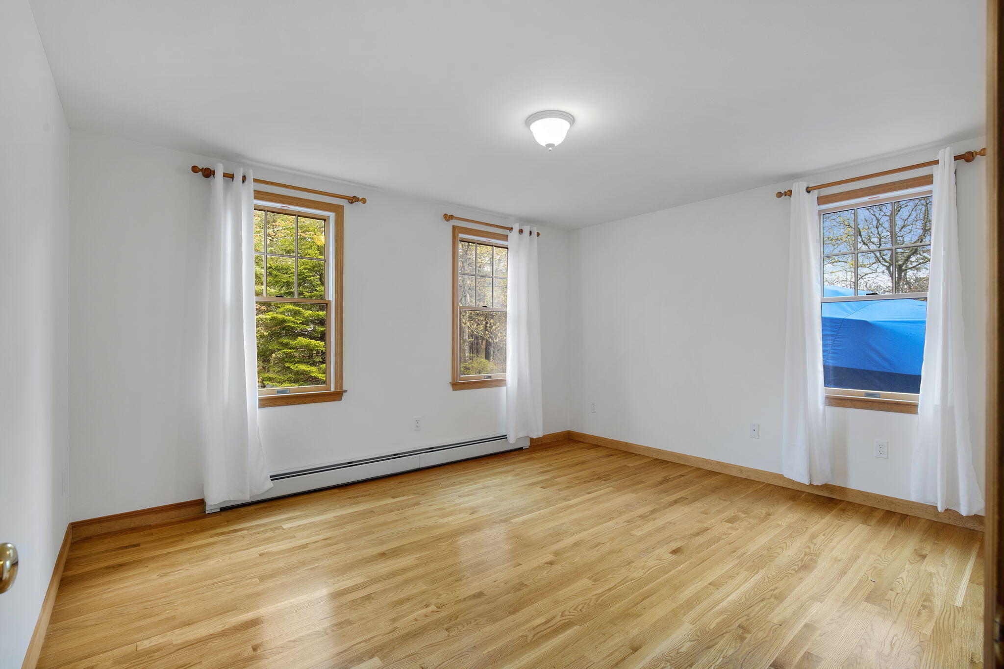65 Whitney Road Eastham, MA 02642 - Photo 22 of 41 a view of an empty room with wooden floor and a window