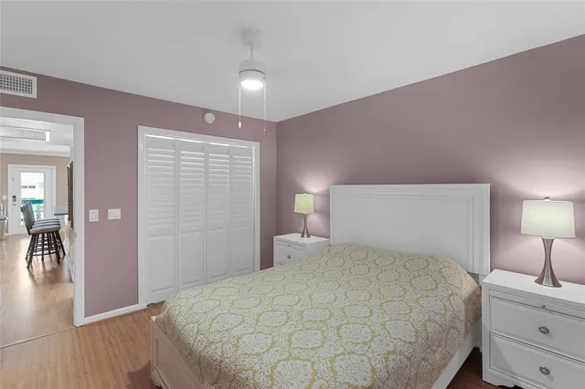 a bedroom with a bed and a lamp