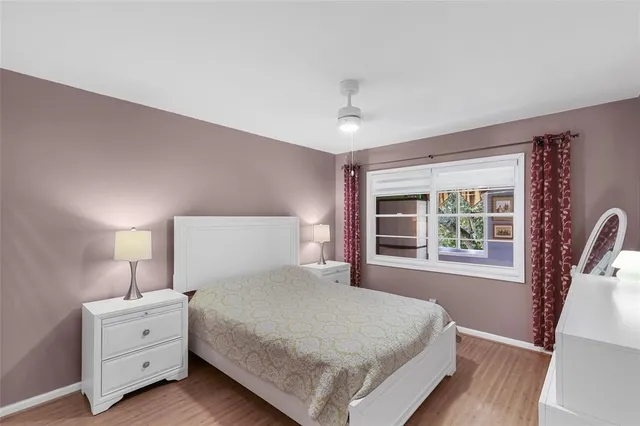 a bedroom with a large bed and a window