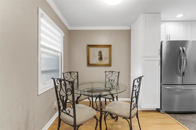 a view of a dining room with furniture and a refrigerator
