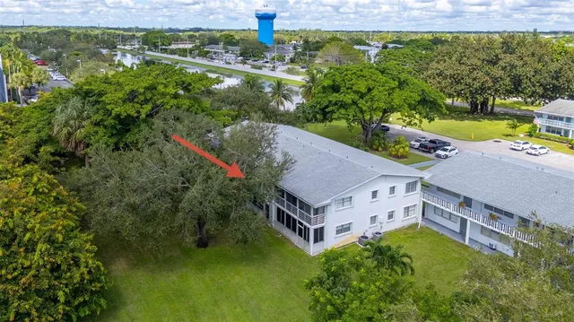 an aerial view of a house with a yard basket ball court and outdoor seating