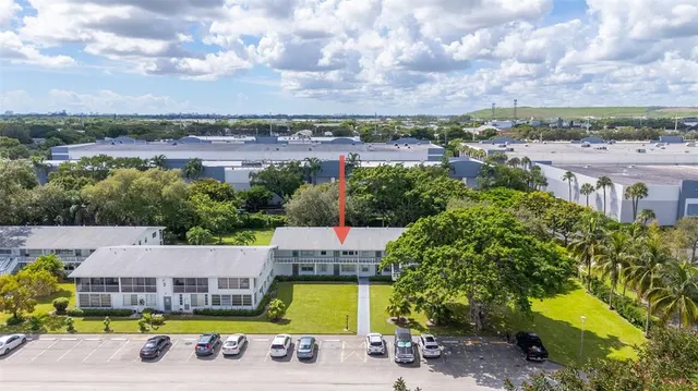 an aerial view of a house with swimming pool and mountains