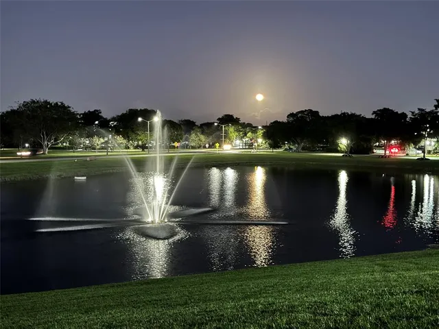 a water fountain in the middle of a lake