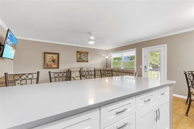 a view of kitchen with center island and living room