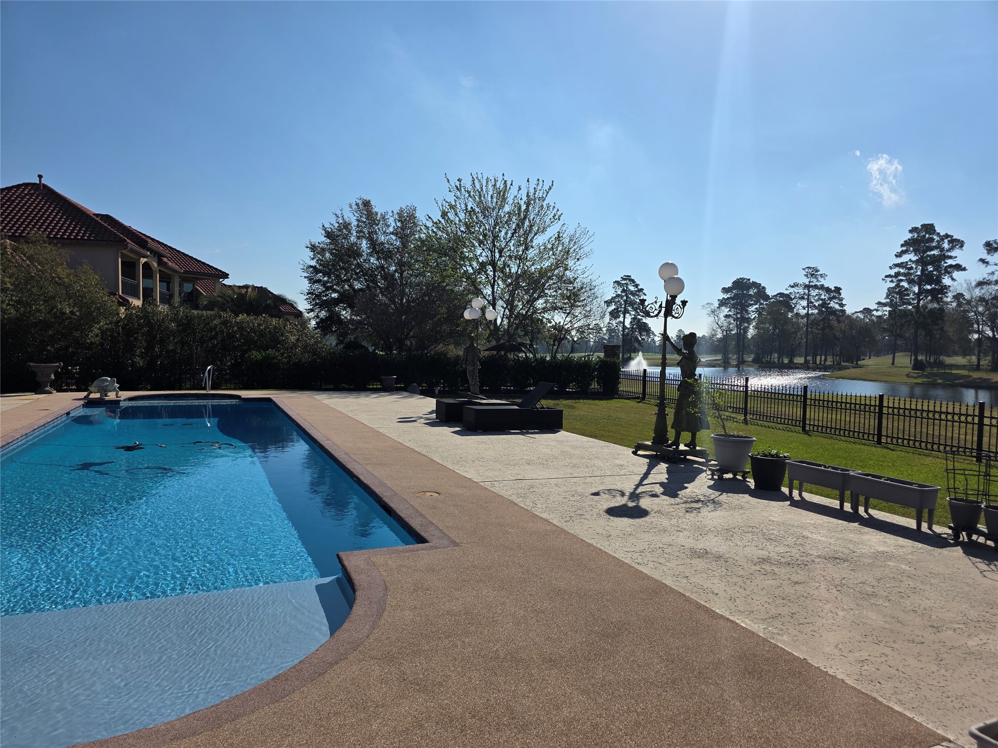7715 Firethorne Creek Court Spring, TX 77389 - Photo 48 of 50 swimming pool with outdoor seating and trees in the background
