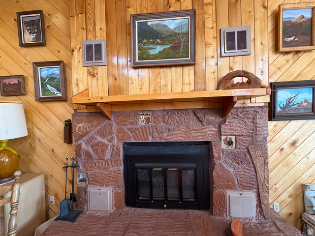 358 South Sky Drive Torrey, UT 84775 - Photo 15 of 82 Stone-clad fireplace featuring a black firebox and a wooden mantel