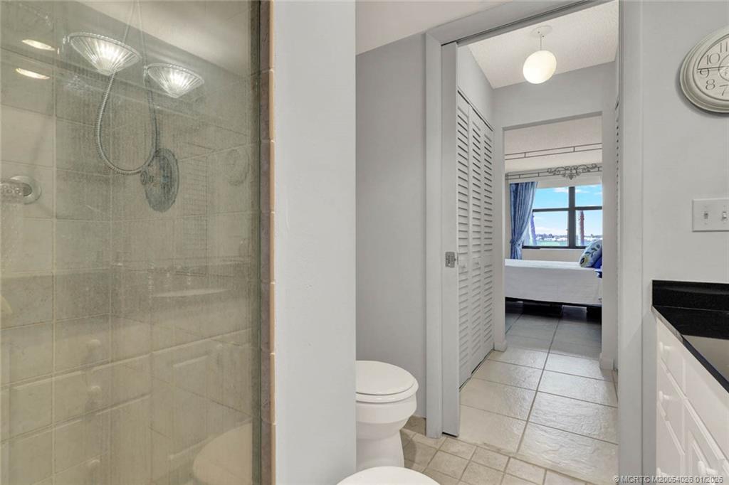 1950 Southwest Palm City Road, Unit 8106 Stuart, FL 34994 - Photo 31 of 54 a bathroom with a toilet a sink and shower