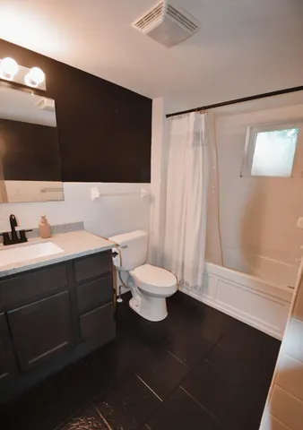 a view of a house with backyard and a tree