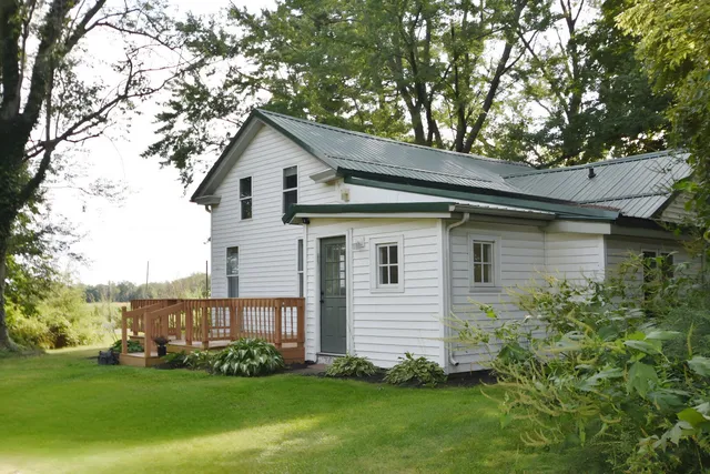 a view of a house with wooden fence