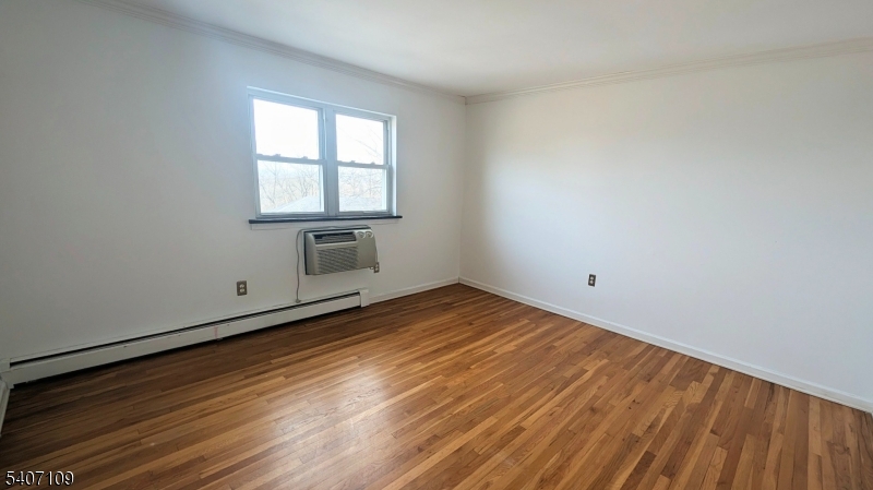2467 Highway 10, Unit 3B Morris Plains, NJ 07950 - Photo 15 of 22 an empty room with wooden floor and windows