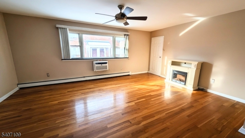 2467 Highway 10, Unit 3B Morris Plains, NJ 07950 - Photo 7 of 22 a view of an empty room with a window and wooden floor