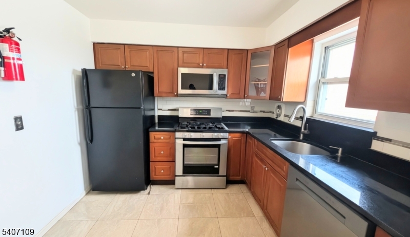 2467 Highway 10, Unit 3B Morris Plains, NJ 07950 - Photo 8 of 22 a kitchen with a refrigerator stove and sink