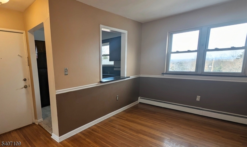 2467 Highway 10, Unit 3B Morris Plains, NJ 07950 - Photo 9 of 22 an empty room with wooden floor and windows