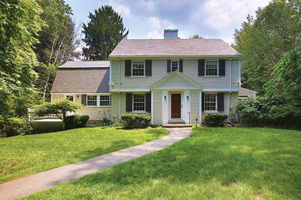 76 Denny Road Brookline, MA 02467 - Photo 1 of 11 a front view of a house with a yard table and chairs