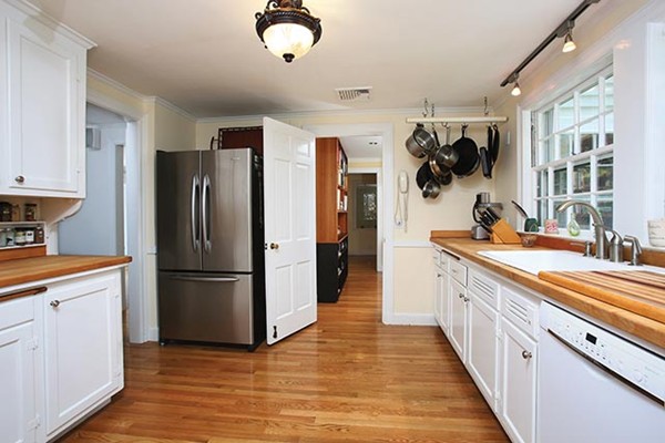 76 Denny Road Brookline, MA 02467 - Photo 4 of 11 a kitchen with a refrigerator and a sink
