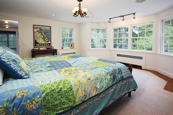 76 Denny Road Brookline, MA 02467 - Photo 5 of 11 a bed sitting in a spacious bedroom next to a window