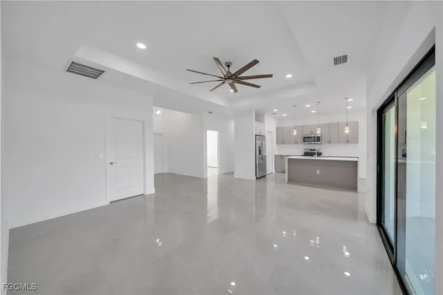a view of a kitchen with a sink and a refrigerator