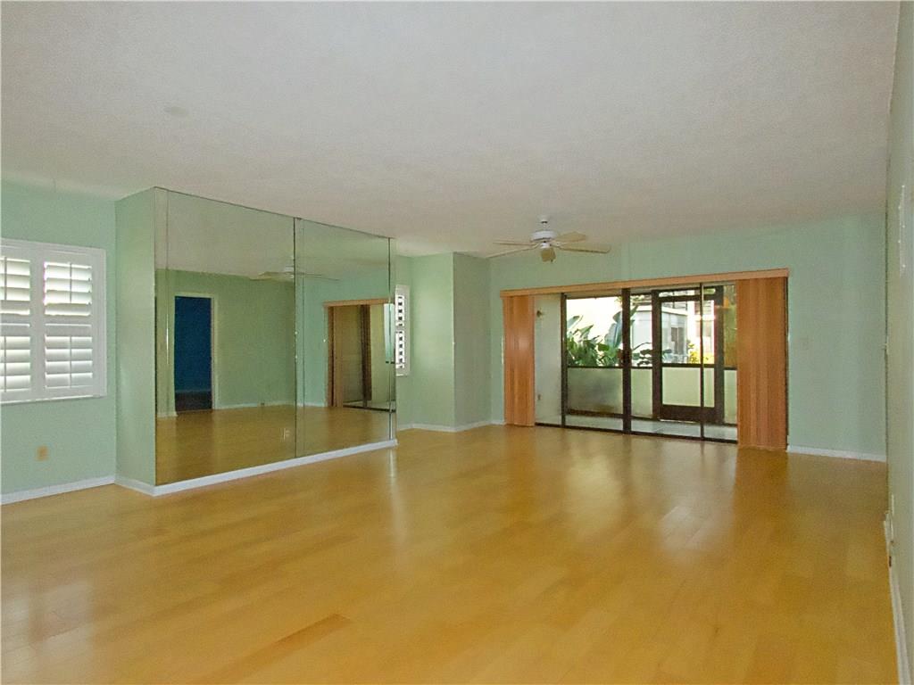 1851 Southwest Palm City Road, Unit E101 Stuart, FL 34994 - Photo 7 of 21 wooden floor in an empty room with a window