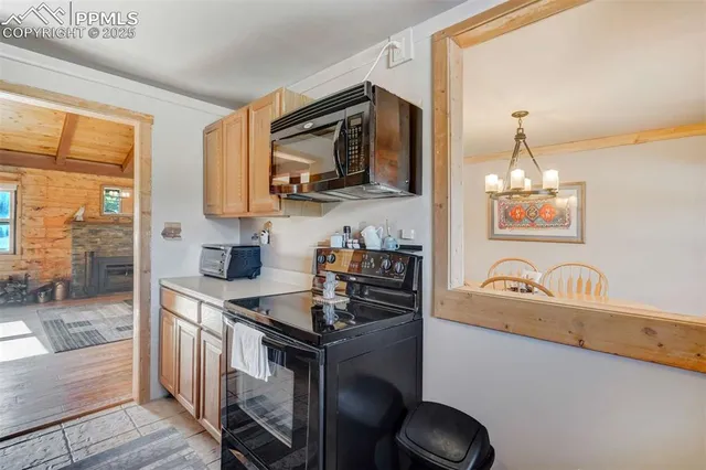 a kitchen with a sink stove and microwave