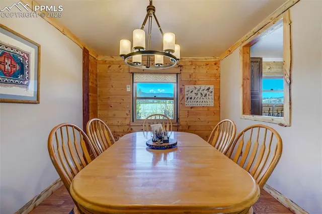 a view of a dining room with furniture wooden floor and chandelier