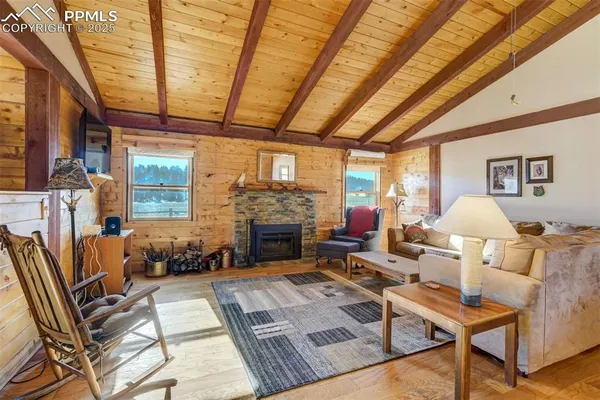 a living room with furniture a fireplace and a table