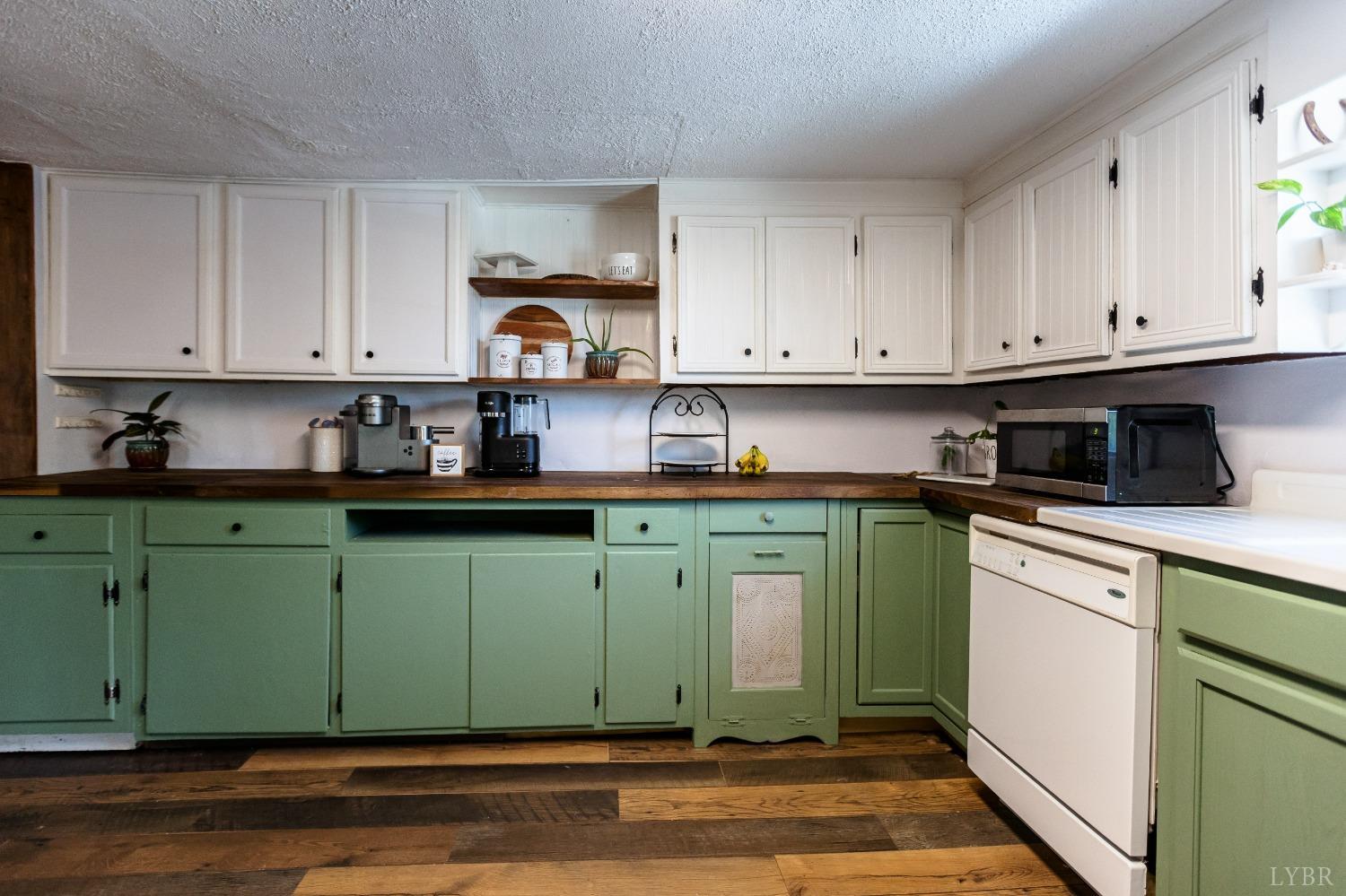 1564 Swan Road Pamplin, VA 23958 - Photo 18 of 60 a kitchen with granite countertop a stove top oven sink and cabinets