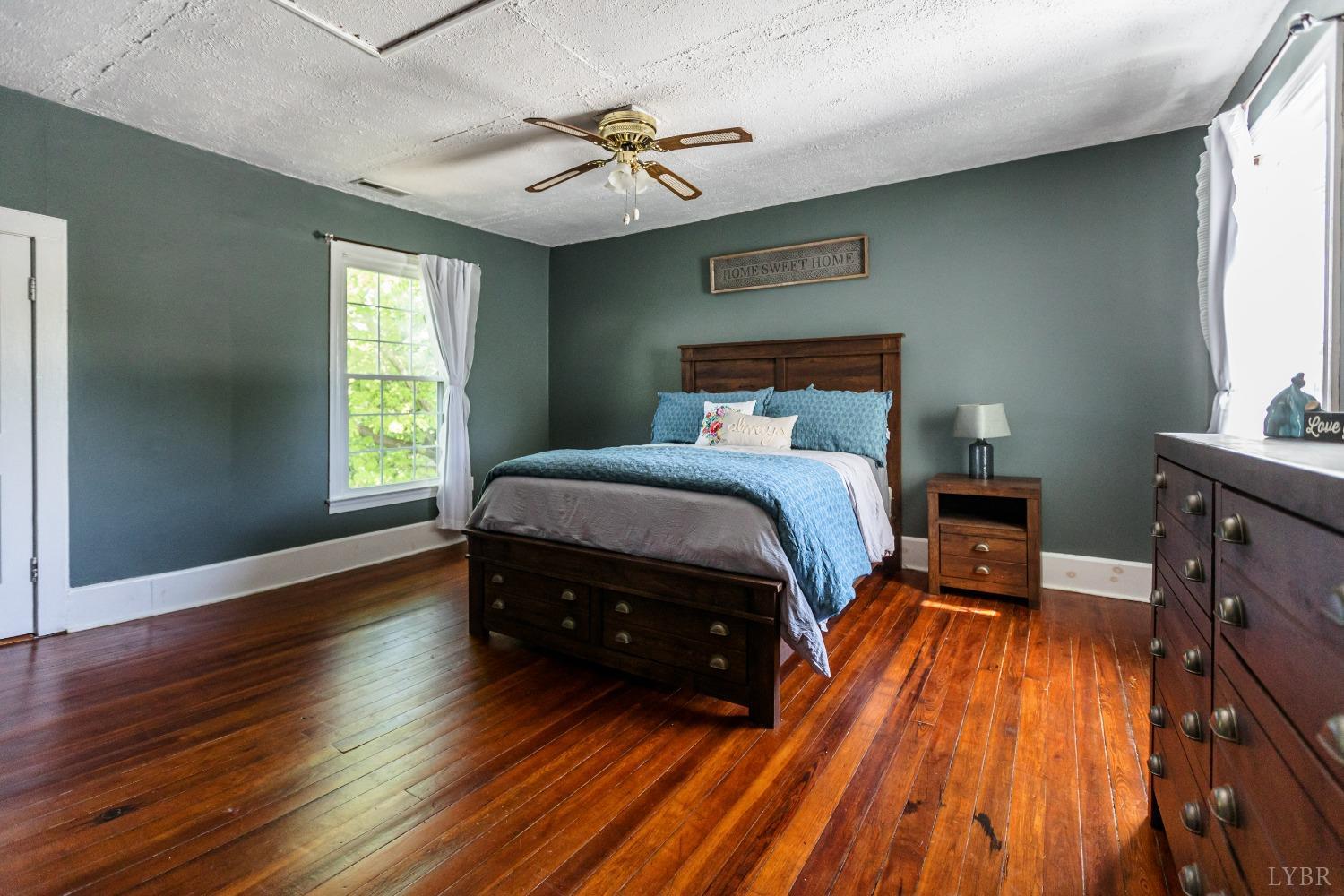 1564 Swan Road Pamplin, VA 23958 - Photo 36 of 60 a bedroom with a bed and a chandelier