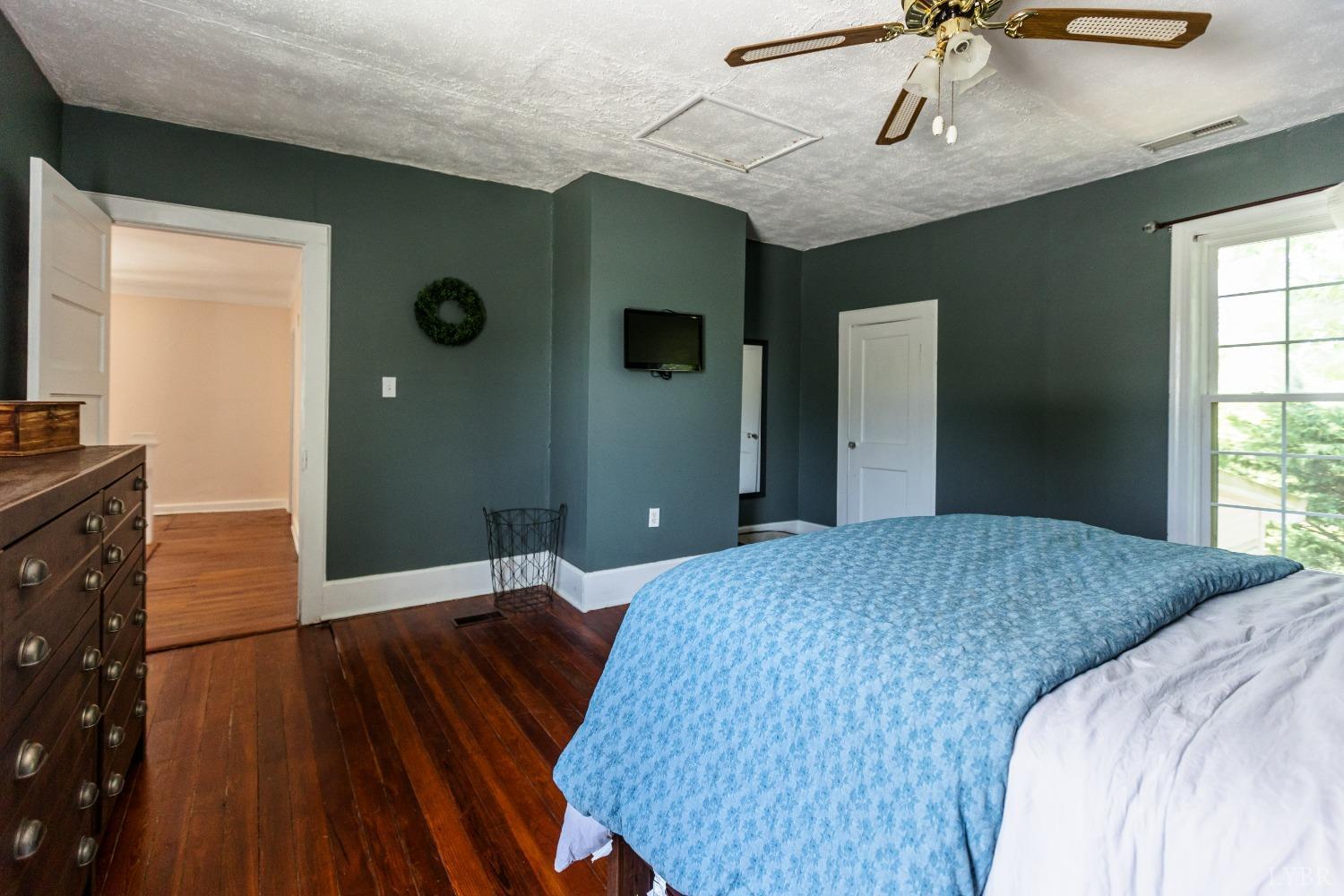 1564 Swan Road Pamplin, VA 23958 - Photo 37 of 60 a bedroom with a bed and a flat tv screen on dresser