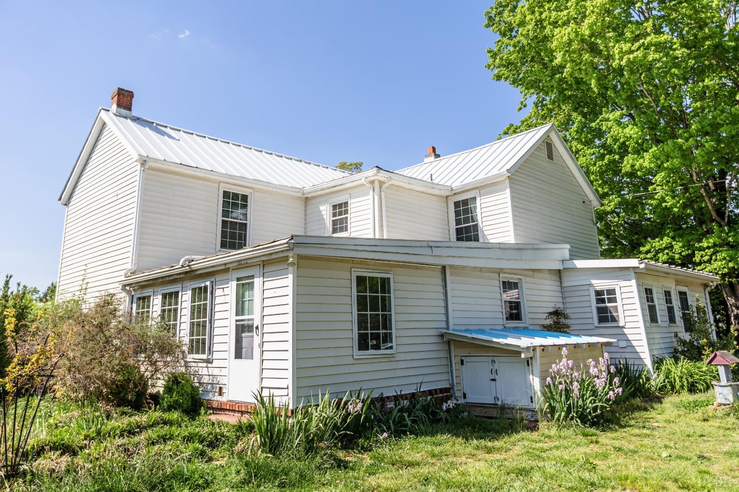 1564 Swan Road Pamplin, VA 23958 - Photo 45 of 60 a front view of a house with a yard and potted plants