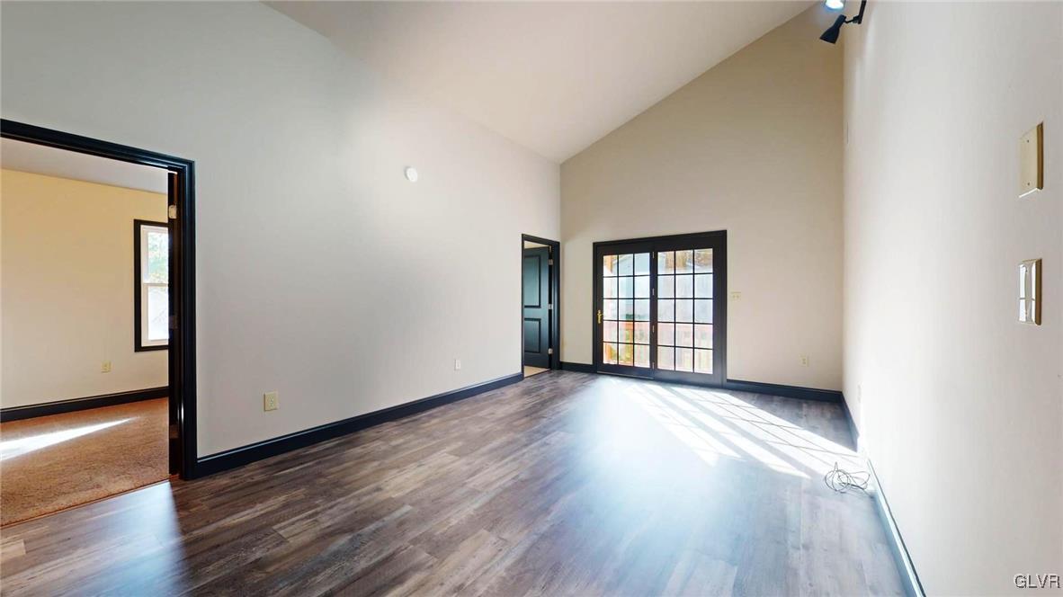8713 Lincoln Green Drive Kunkletown, PA 18058 - Photo 16 of 42 a view of an empty room with wooden floor and a window