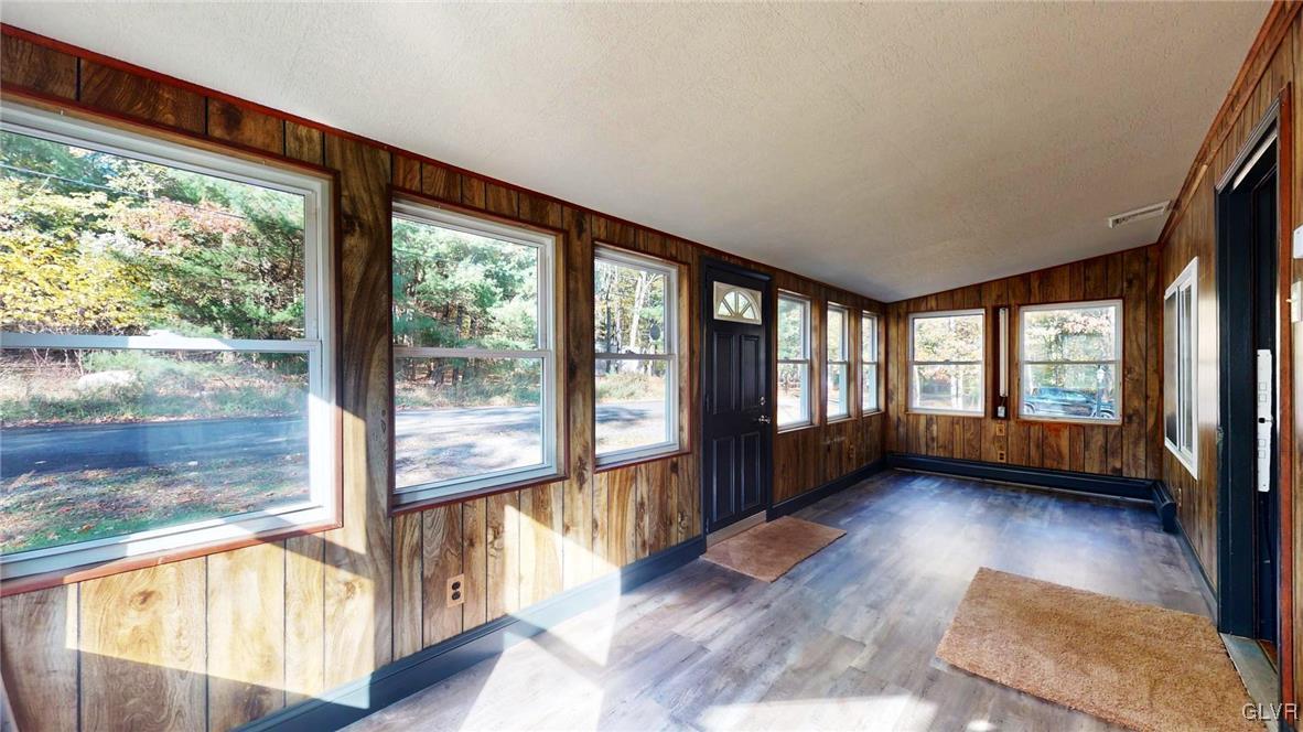 8713 Lincoln Green Drive Kunkletown, PA 18058 - Photo 3 of 42 a view of an empty room with wooden floor and a window