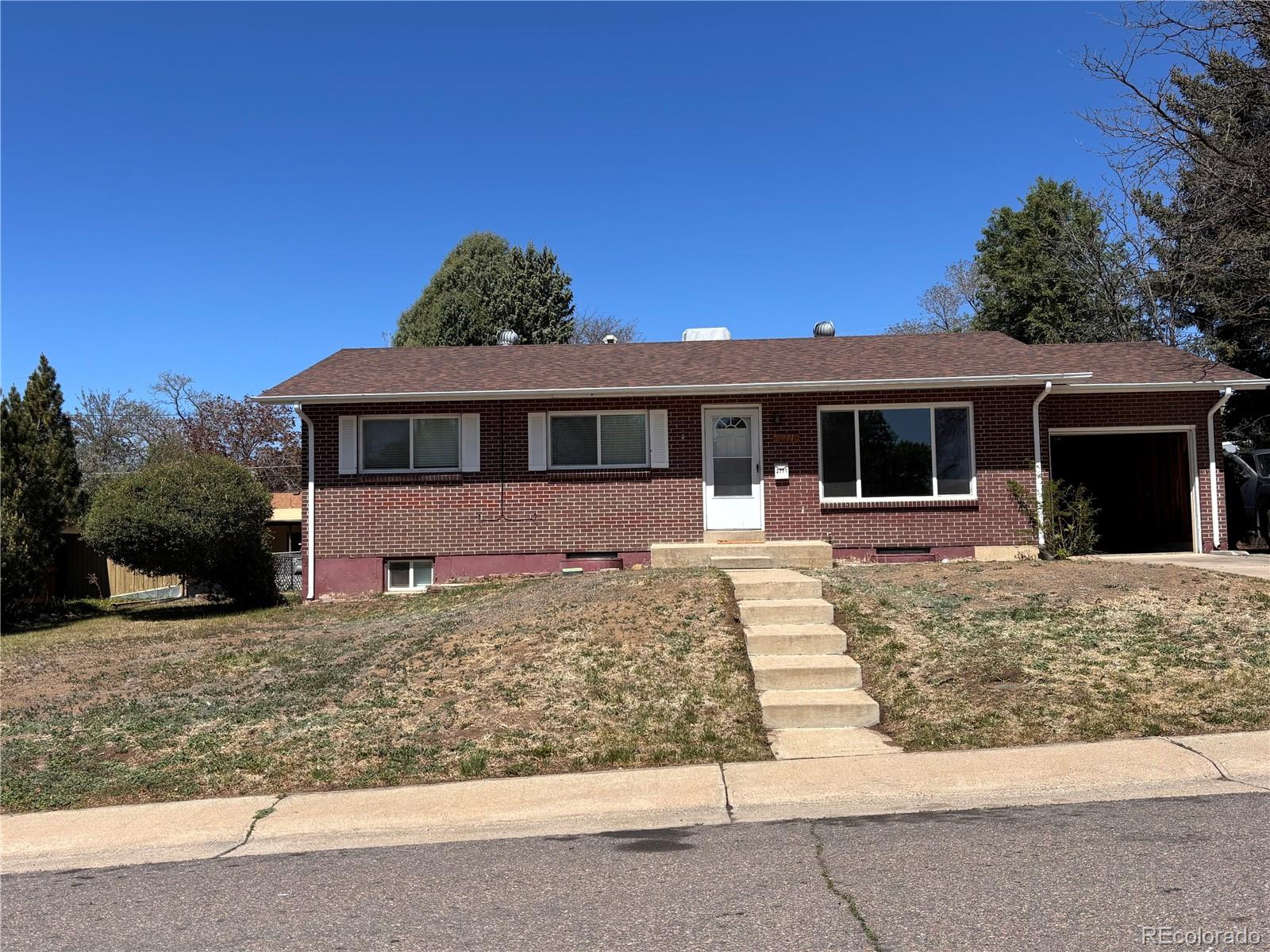 2771 South Perry Street Denver, CO 80236 - Photo 1 of 40 a front view of a house with a yard