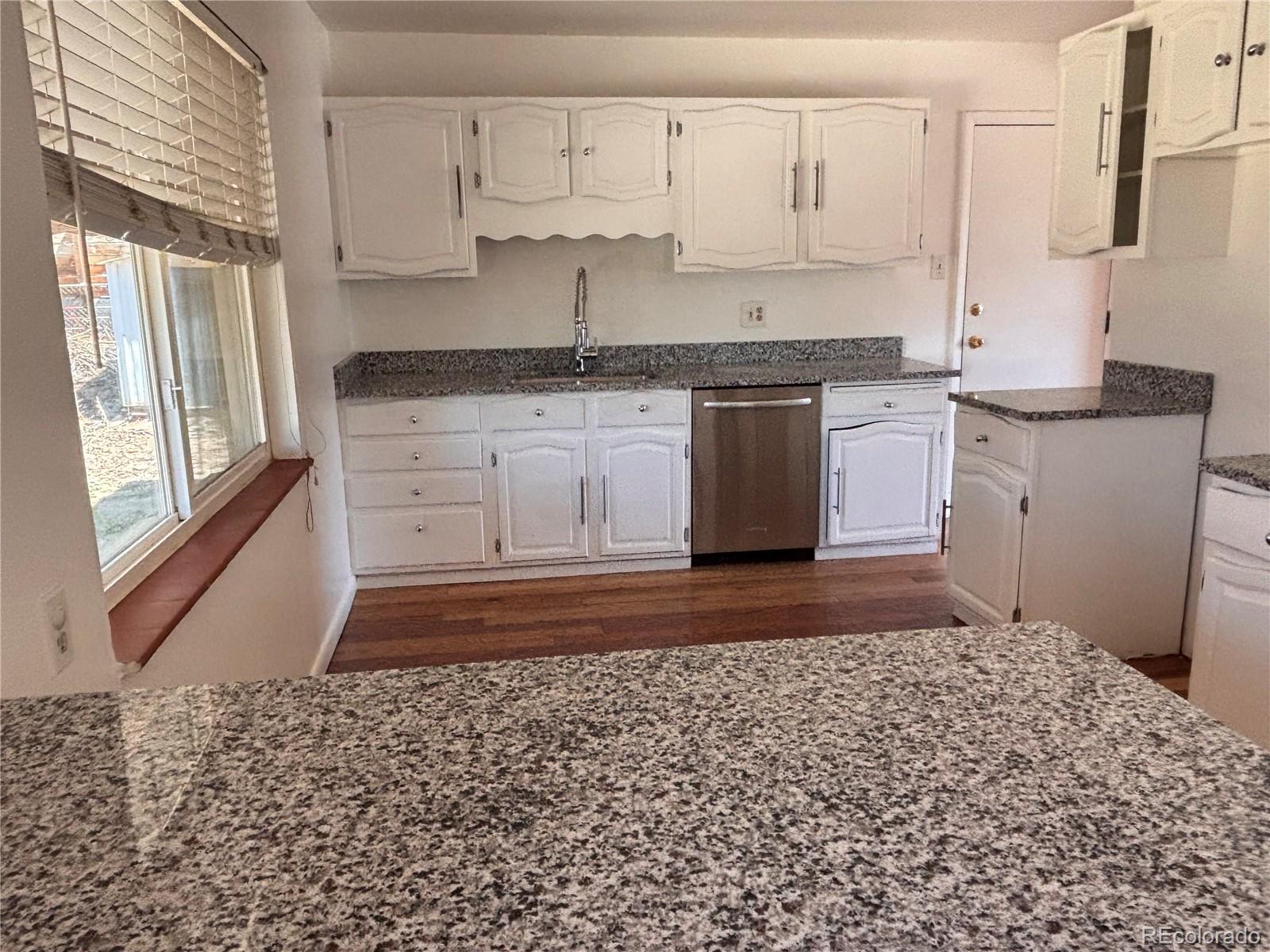 2771 South Perry Street Denver, CO 80236 - Photo 11 of 40 a kitchen with a sink window and cabinets