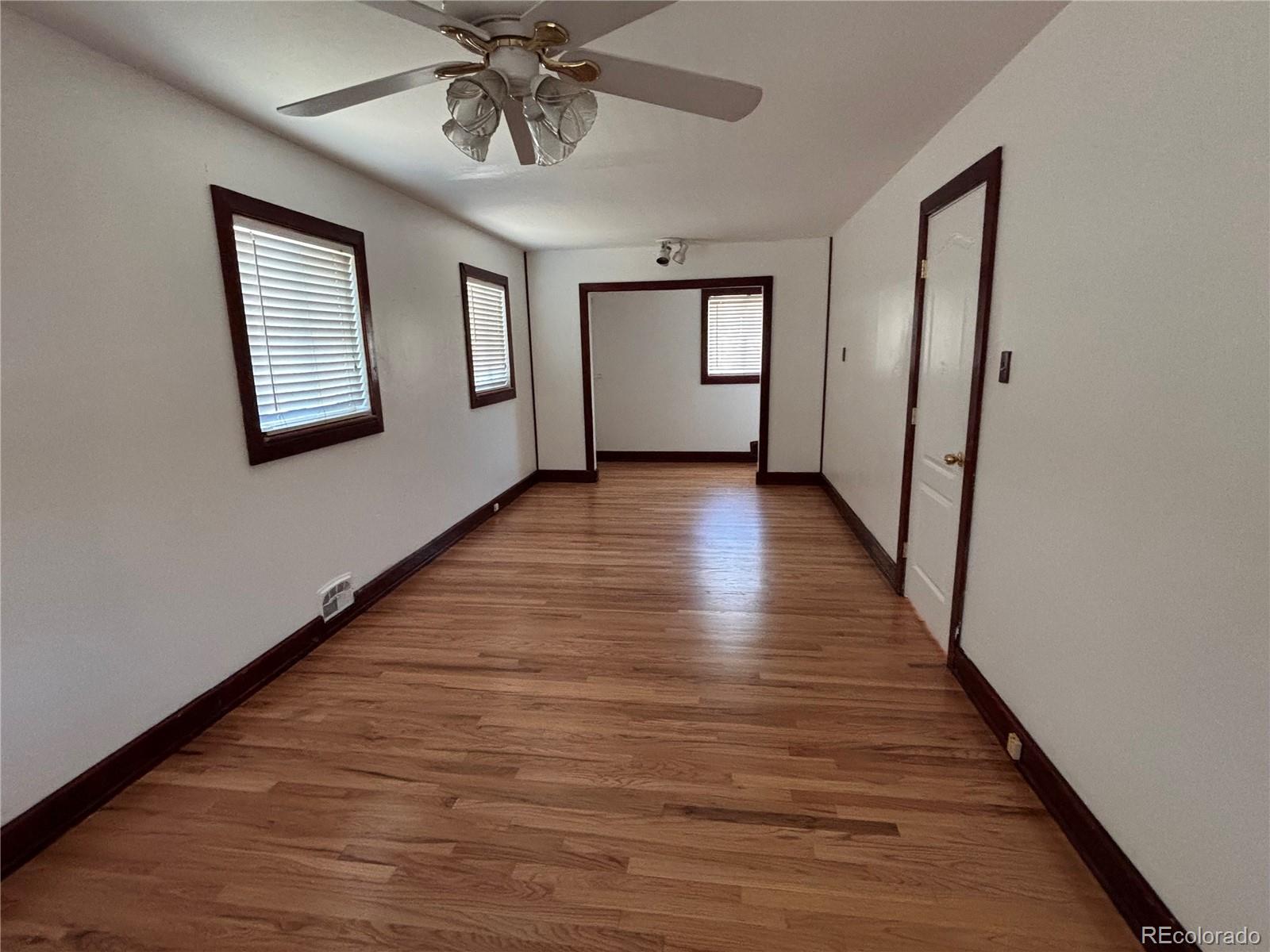 2771 South Perry Street Denver, CO 80236 - Photo 16 of 40 a view of an entryway with wooden floor