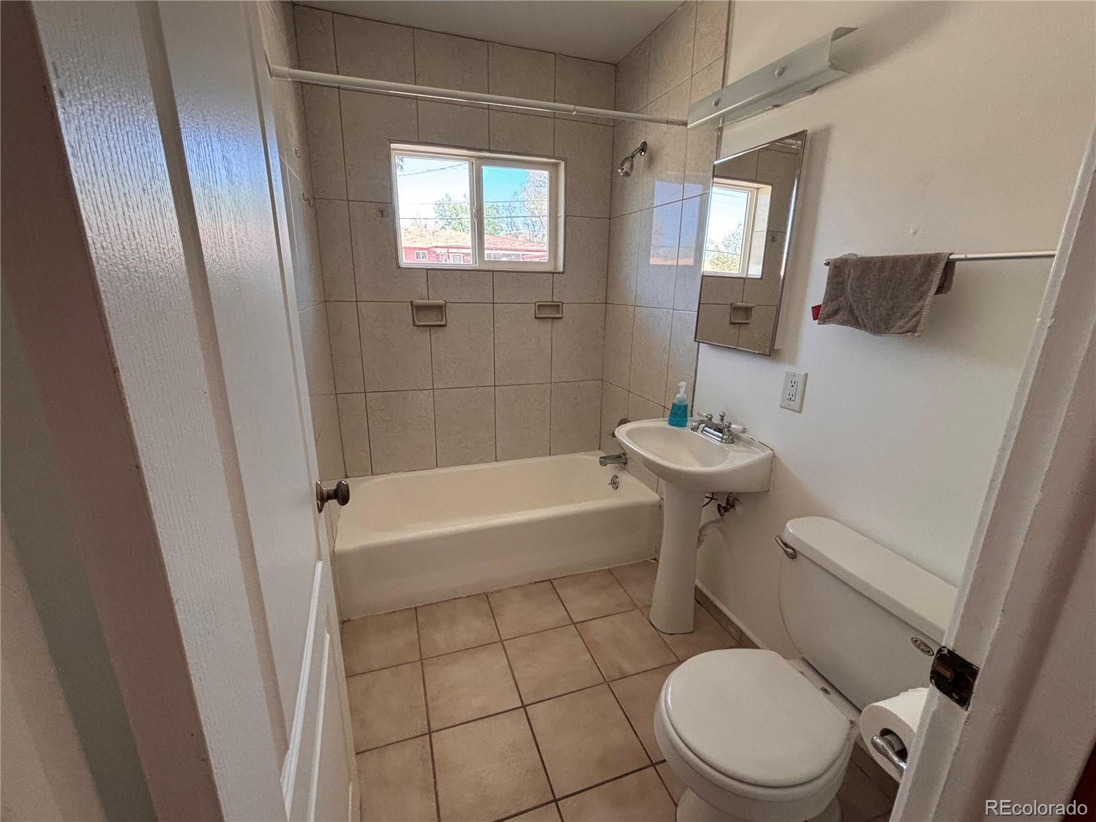 2771 South Perry Street Denver, CO 80236 - Photo 18 of 40 a bathroom with a sink toilet and shower