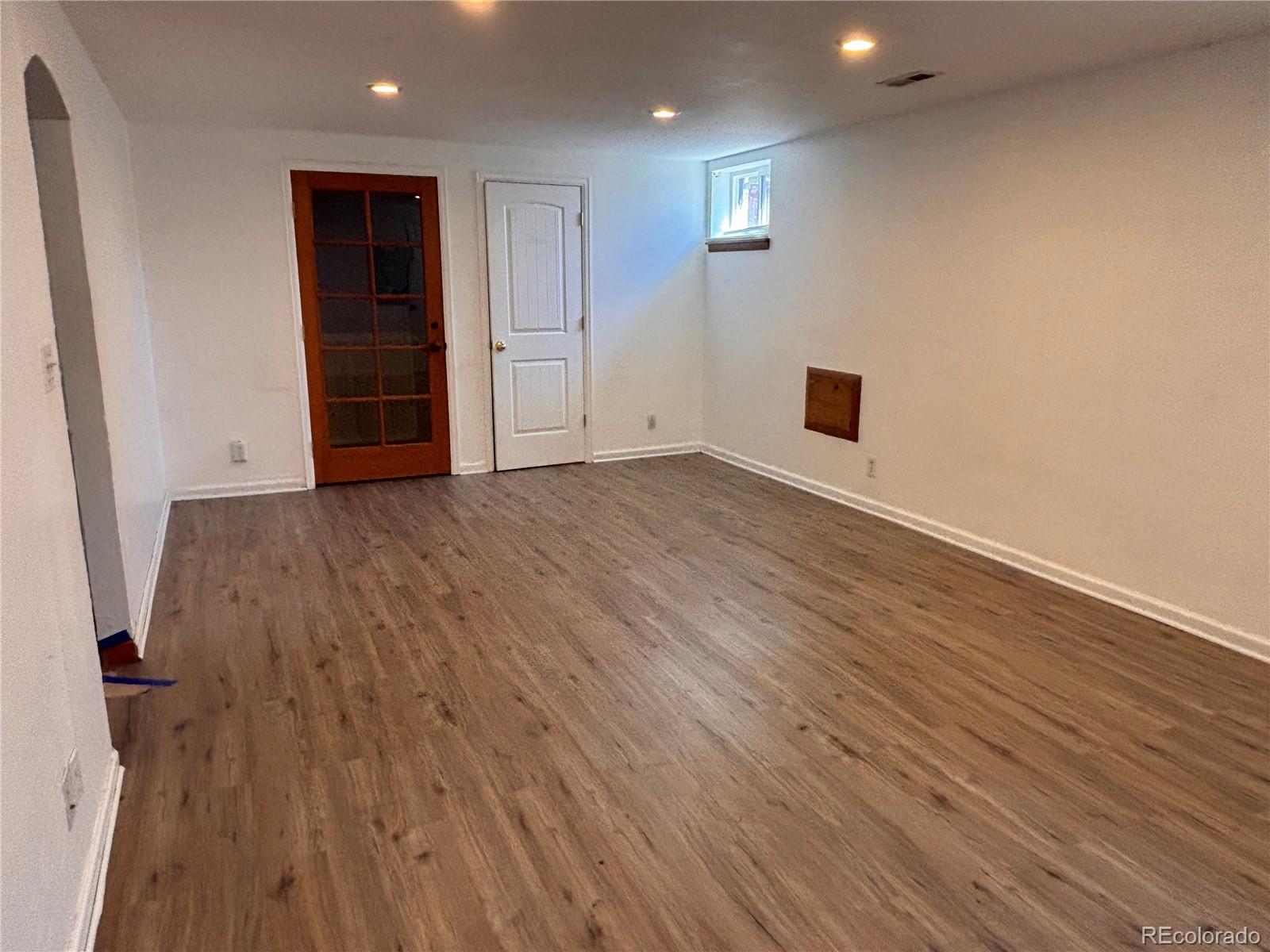 2771 South Perry Street Denver, CO 80236 - Photo 20 of 40 an empty room with wooden floor and windows