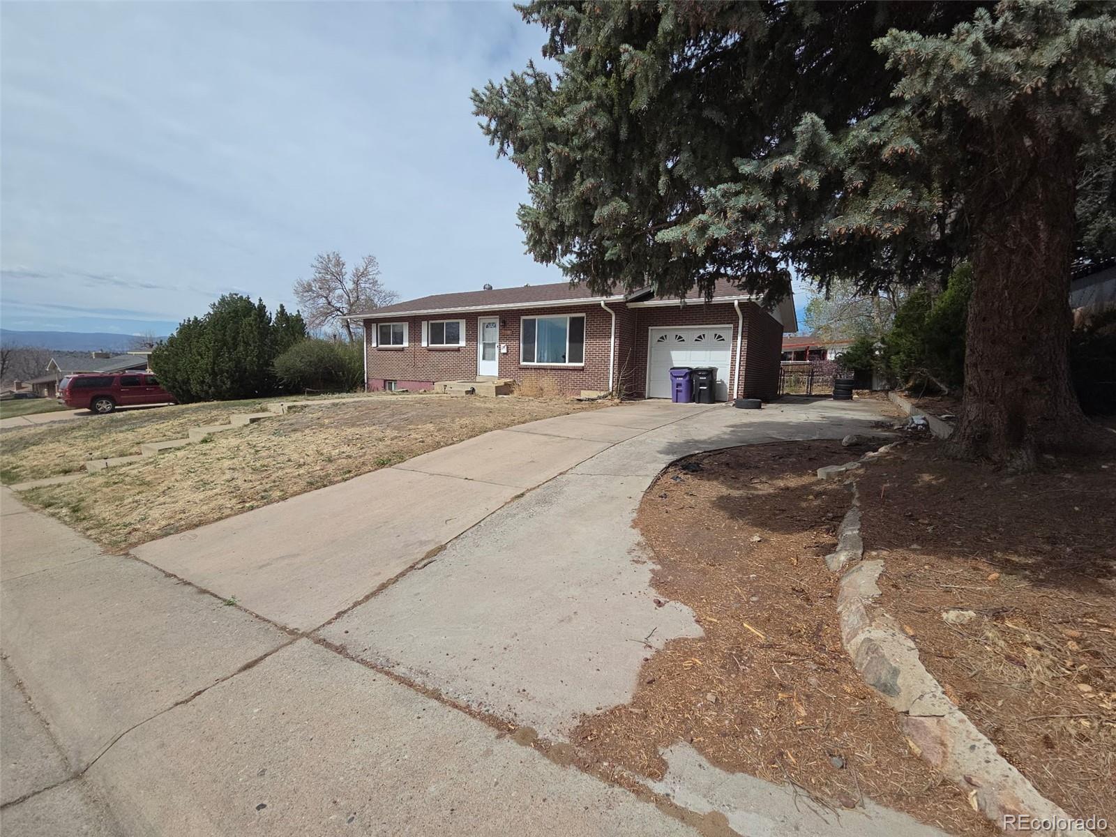 2771 South Perry Street Denver, CO 80236 - Photo 2 of 2 a front view of a house with a garden