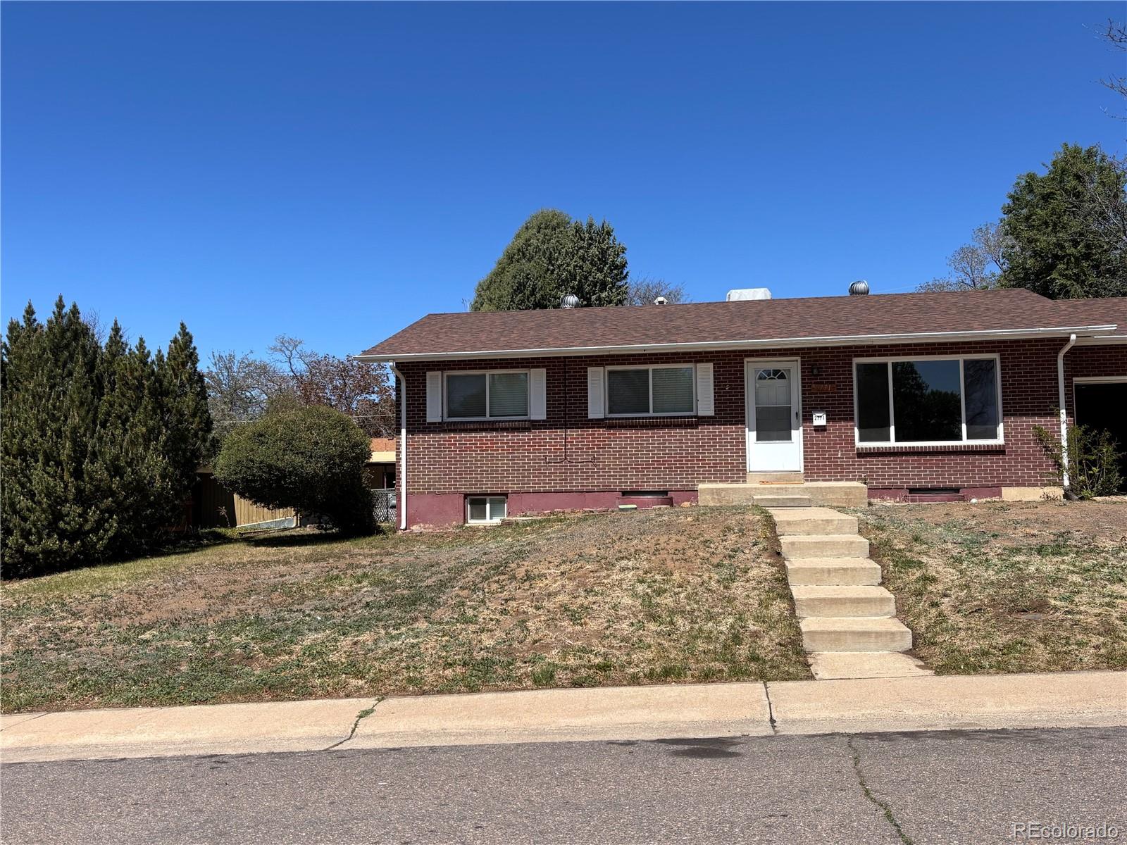 2771 South Perry Street Denver, CO 80236 - Photo 2 of 40 a front view of a house with a yard