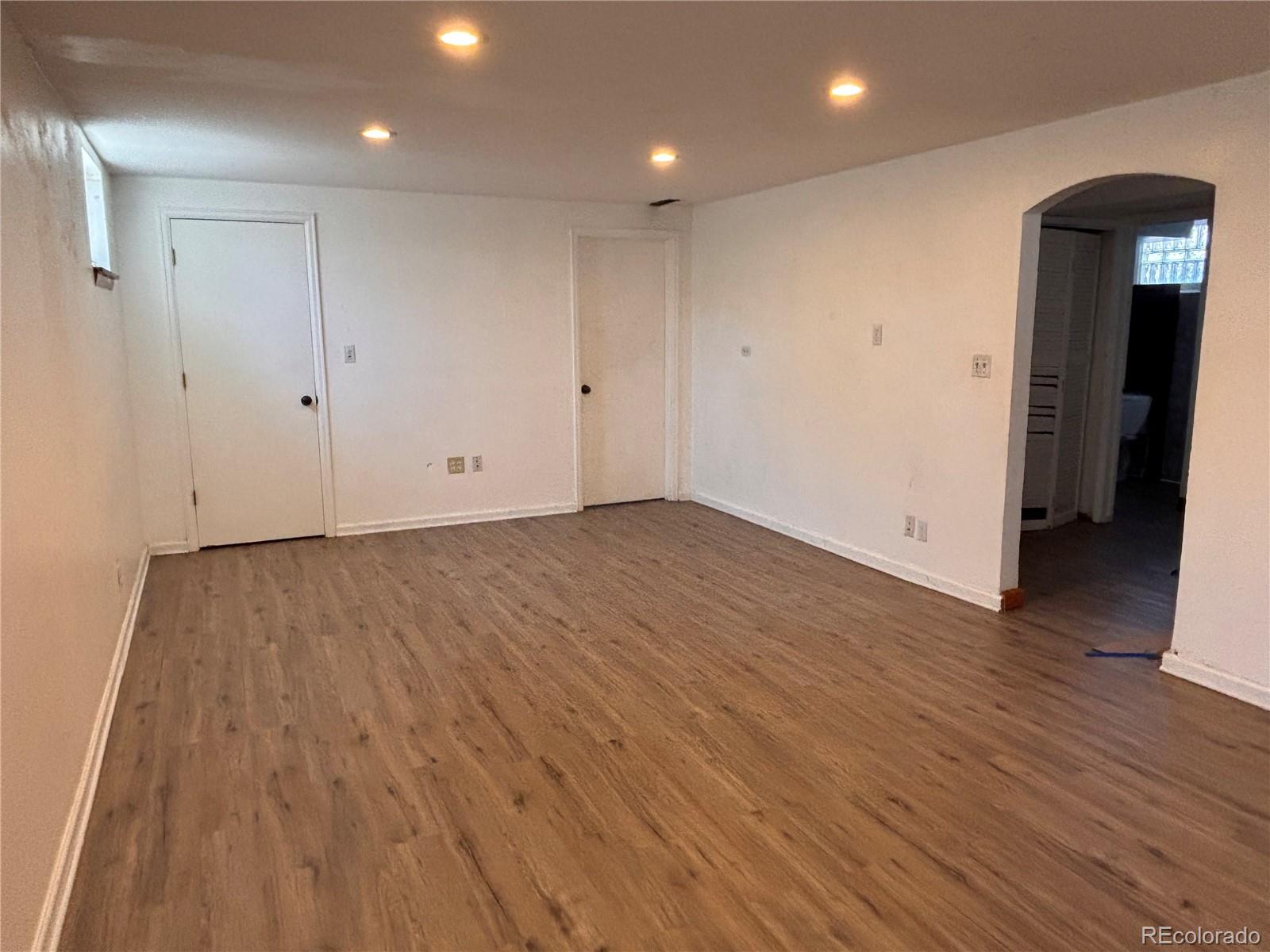 2771 South Perry Street Denver, CO 80236 - Photo 21 of 40 an empty room with wooden floor and closet