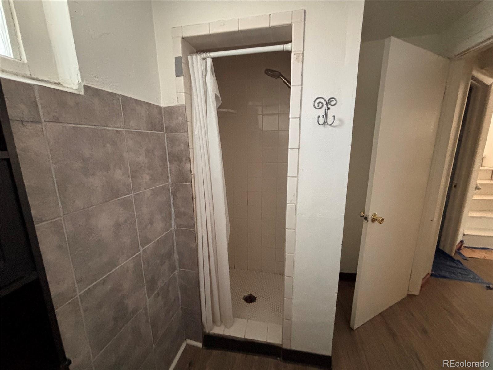 2771 South Perry Street Denver, CO 80236 - Photo 26 of 40 a bathroom with a glass door shower