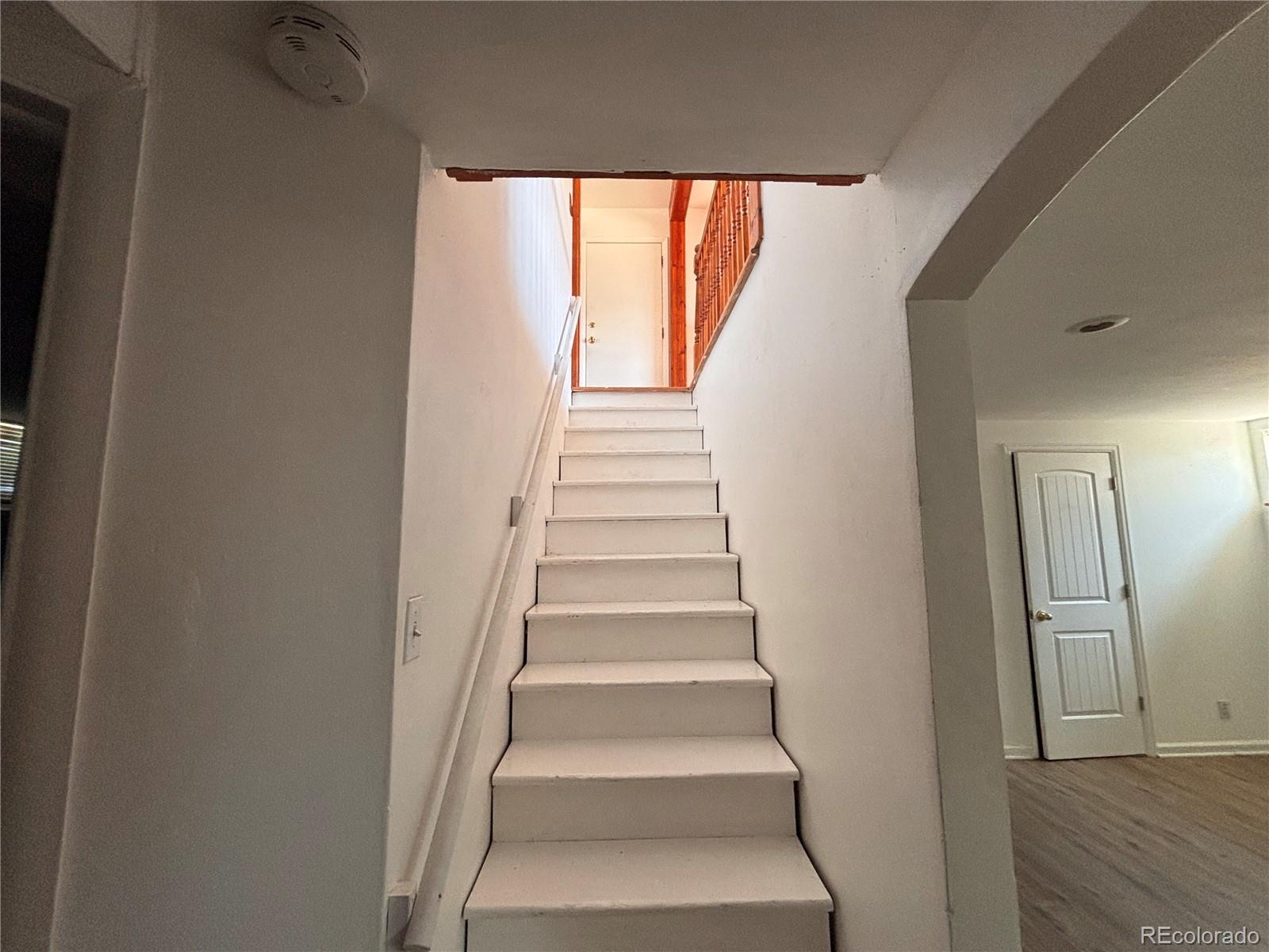 2771 South Perry Street Denver, CO 80236 - Photo 30 of 40 a view of staircase with white walls and a window