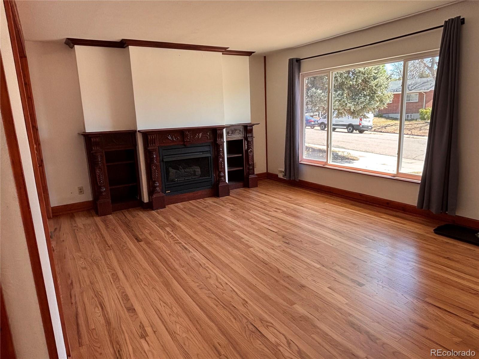 2771 South Perry Street Denver, CO 80236 - Photo 6 of 40 a view of a room with furniture and wooden floor