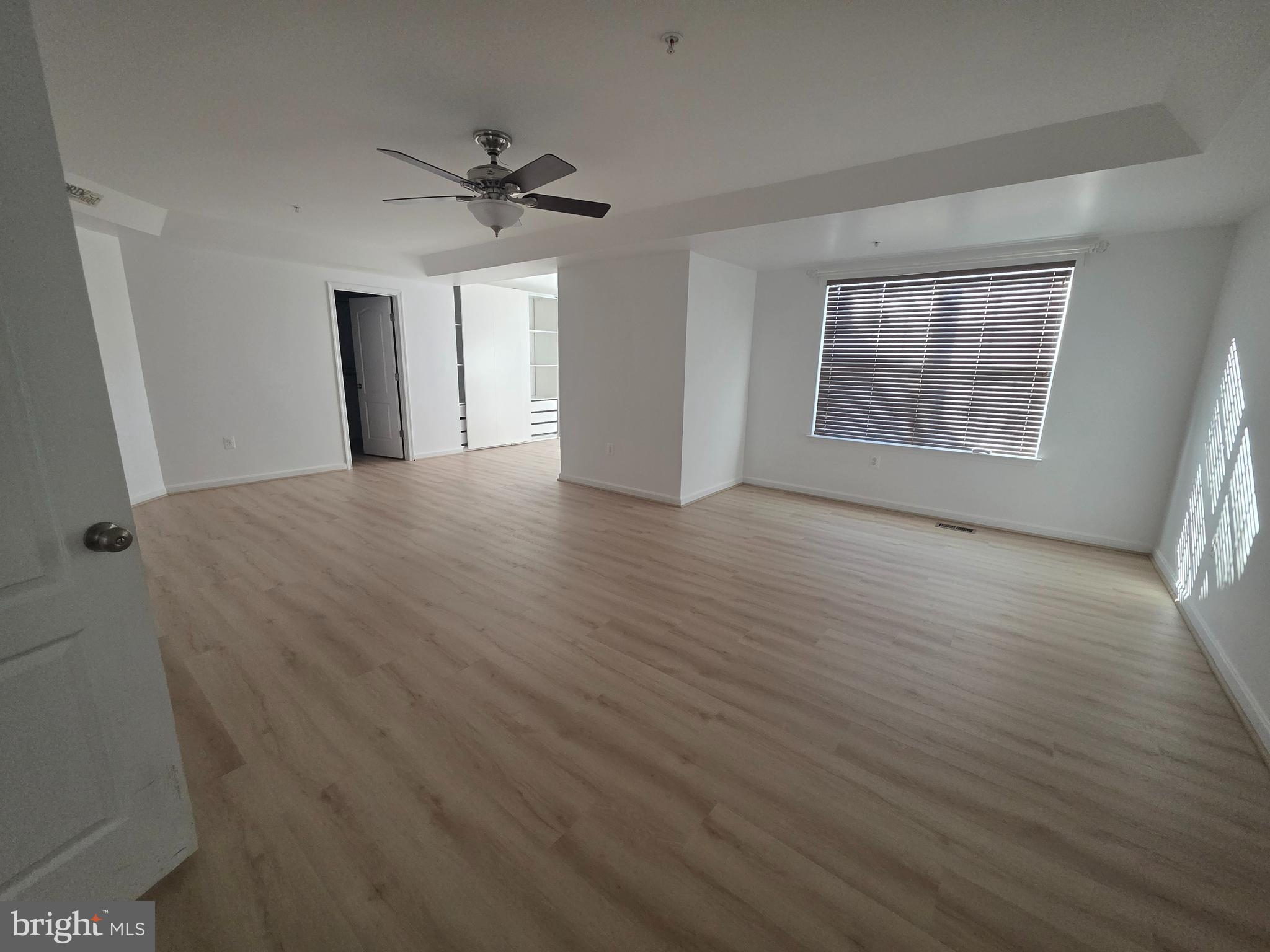 2409 Barrett Court Frederick, MD 21702 - Photo 12 of 19 a view of a livingroom with wooden floor and a ceiling fan